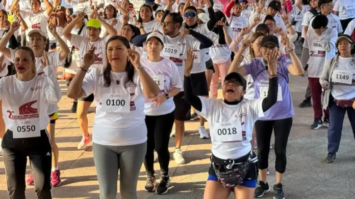 articipantes realizan calentamiento previo durante la Segunda Carrera Recreativa por la Paz y la Participación Comunitaria en Azcapotzalco, con corredores de distintas edades reunidos en la zona centro de la alcaldía.